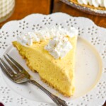 Piece of Eggnog Pie on a plate topped with whipped cream and a fork sitting beside - 11