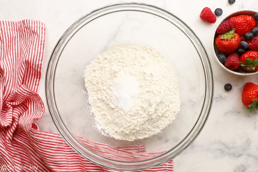 overhead of flour, salt, and baking soda in a bowl to make waffles