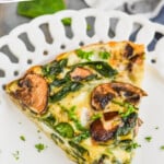 pinterest graphic of a piece of crustless spinach quiche on a white plate, says: the best crustless quiche simplejoy.com