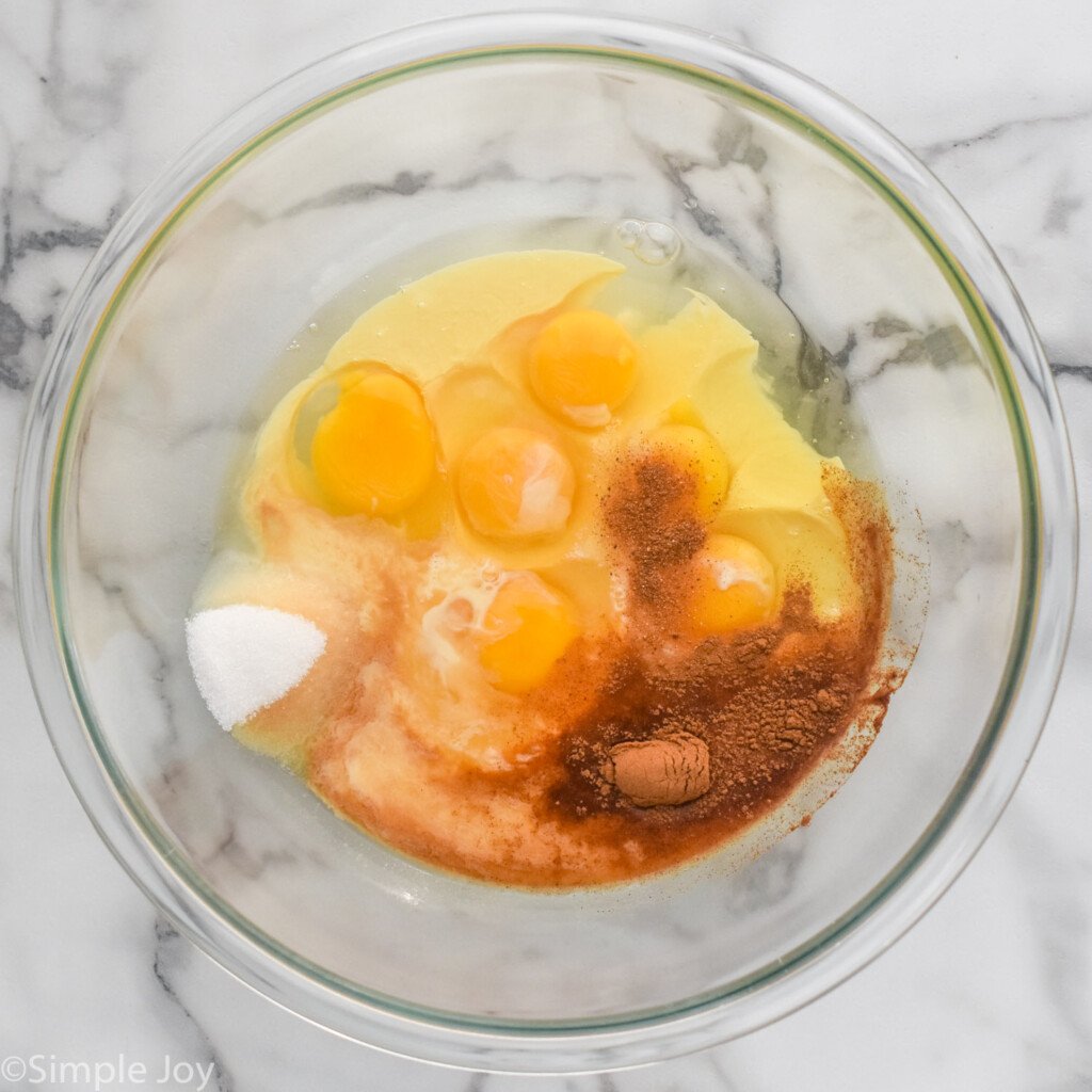 overhead of glass bowl of Eggnog French Toast ingredients