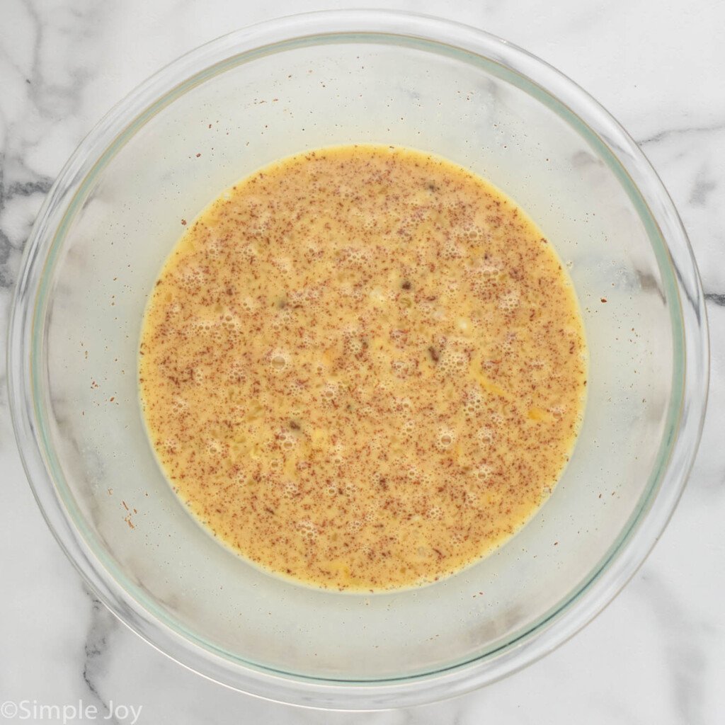 overhead of bowl of batter ingredients to make Eggnog French Toast
