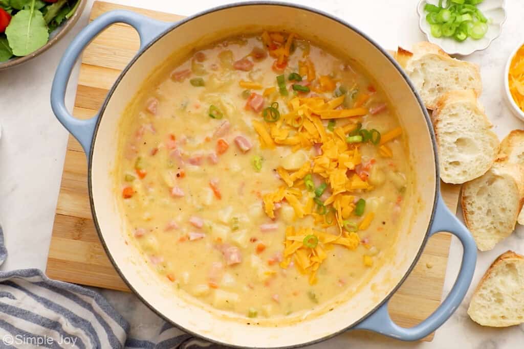 Overhead of large stockpot of ham and potato soup ingredients