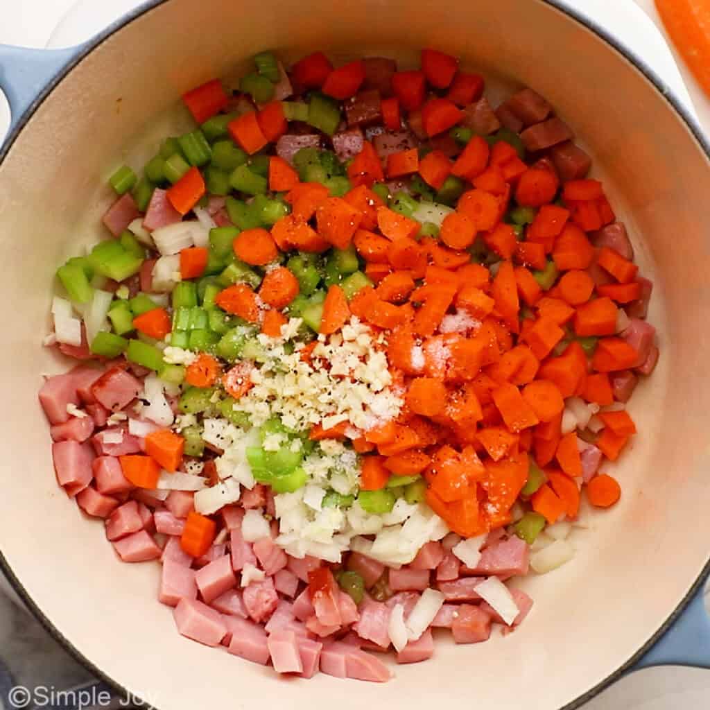 overhead of vegetables and ham in a stock pot