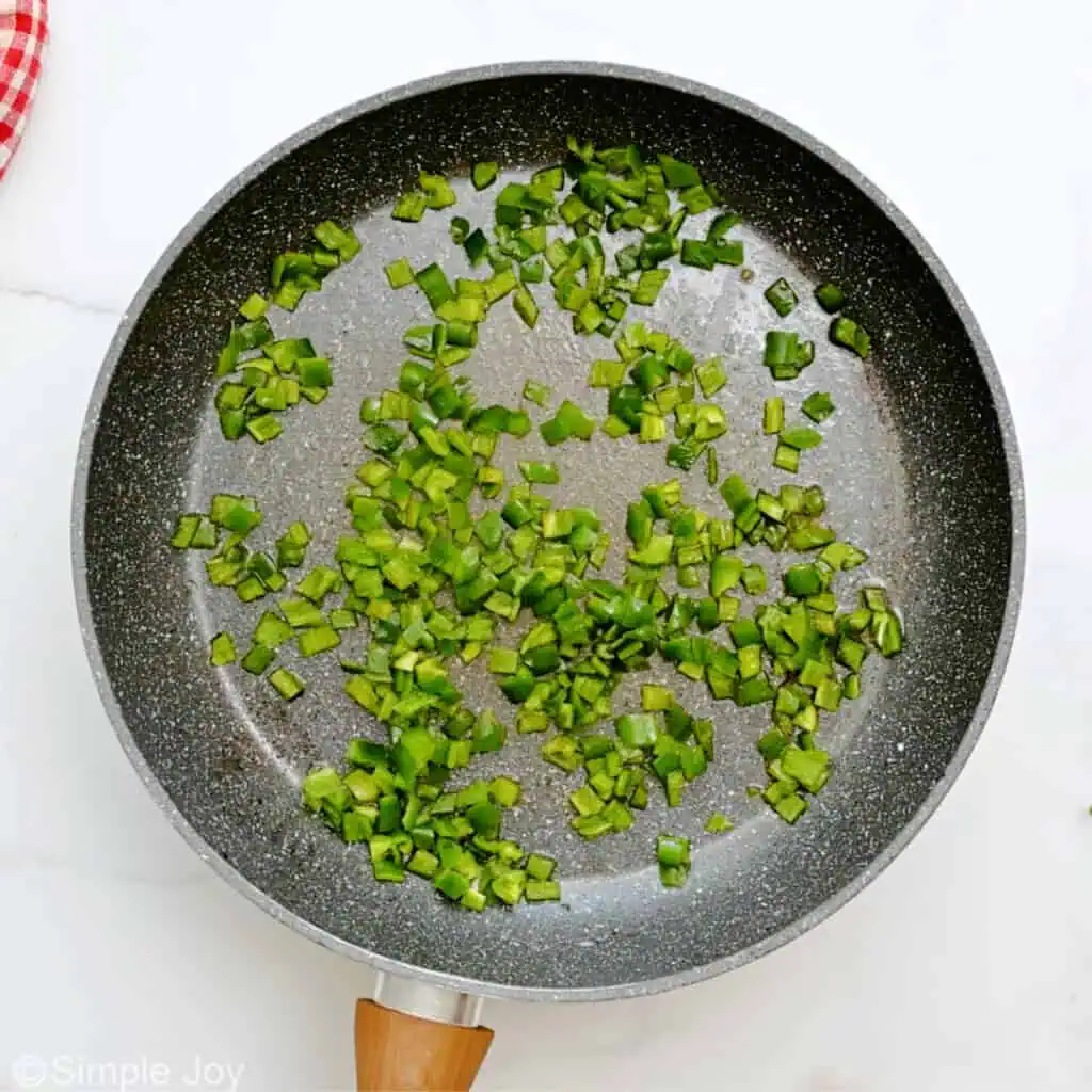 diced jalapeños cooking in a pan