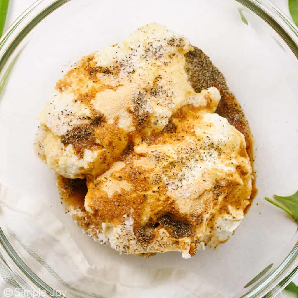 mayonnaise and sour cream in a bowl with spices and Worcestershire sauce to make spinach dip