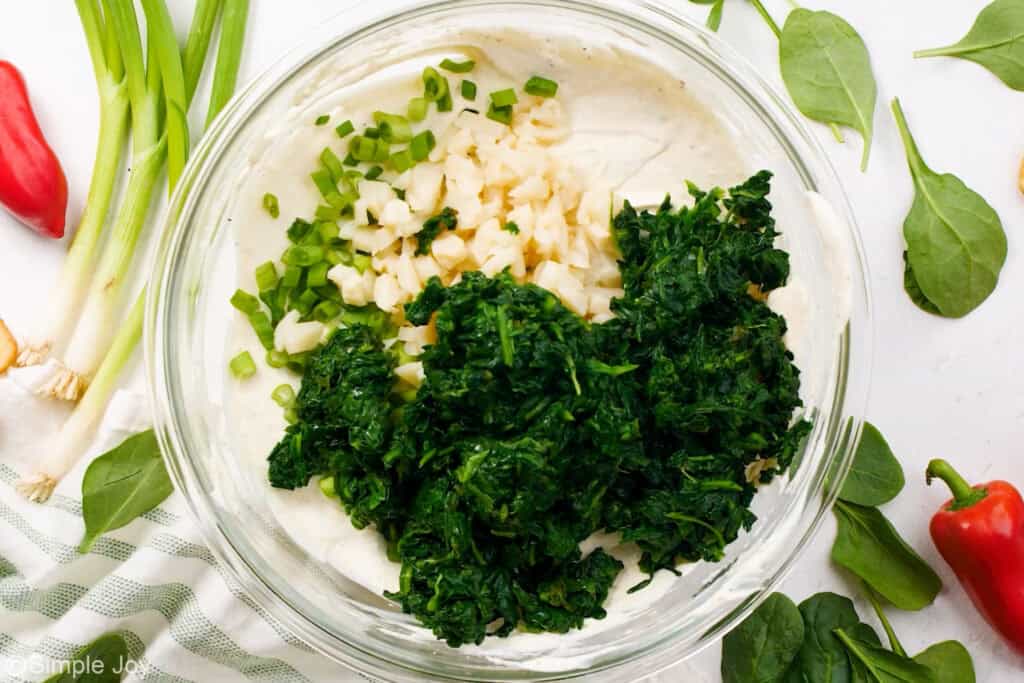overhead of a bowl of ingredients to make spinach dip