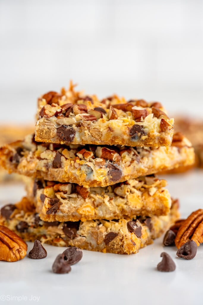 a stack of magic cookie bars - 5