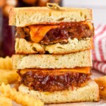 two meatloaf sandwiches on top of each other with french fries sitting beside - 7