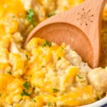Close up of a wooden spoon in a casserole dish of Chicken and Rice Casserole recipe. - 11