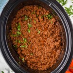 Overhead view of Slow Cooker Taco Meat in a crock pot garnished with cilantro - 11