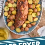 Pinterest graphic for Air Fryer Pork Tenderloin recipe. Image is overhead view of a platter with Air Fryer Pork Tenderloin and cooked potatoes. Text says, "Air Fryer Pork Tenderloin simplejoy.com"