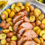 Pinterest graphic for Air Fryer Pork Tenderloin recipe. Text says, "Air Fryer Pork Tenderloin simplejoy.com." Image shows a platter of slices of Air Fryer Pork Tenderloin with potatoes.