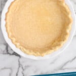 Pinterest graphic for how to blind bake a pie crust recipe. Image is overhead view of blind bake pie crust. Text says, "how to: Blind bake pie crust simplejoy.com."