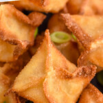 Pinterest graphic for Crab Rangoon recipe. Text says, "the best Crab Rangoon simplejoy.com." Image is close up view of Crab Rangoon garnished with sliced green onions.