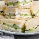 Pinterest graphic for cucumber sandwich. Image shows a plate of cut cucumber sandwiches. Says "super easy cucumber sandwich simplejoy.com"