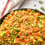 pinterest graphic of a serving bowl full of easy fried rice recipe says: the best easy fried rice recipe simplejoy.com