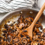 Pinterest graphic for Sautéed Mushrooms recipe. Text says, "delicious Sautéed Mushrooms simplejoy.com." Image shows a skillet of Sautéed Mushrooms with a wooden spoon.