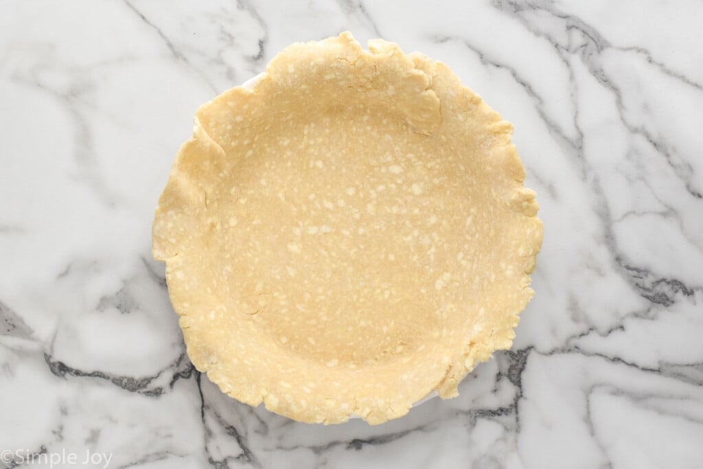 Overhead view of pie crust in a pan for how to blind bake a pie crust recipe
