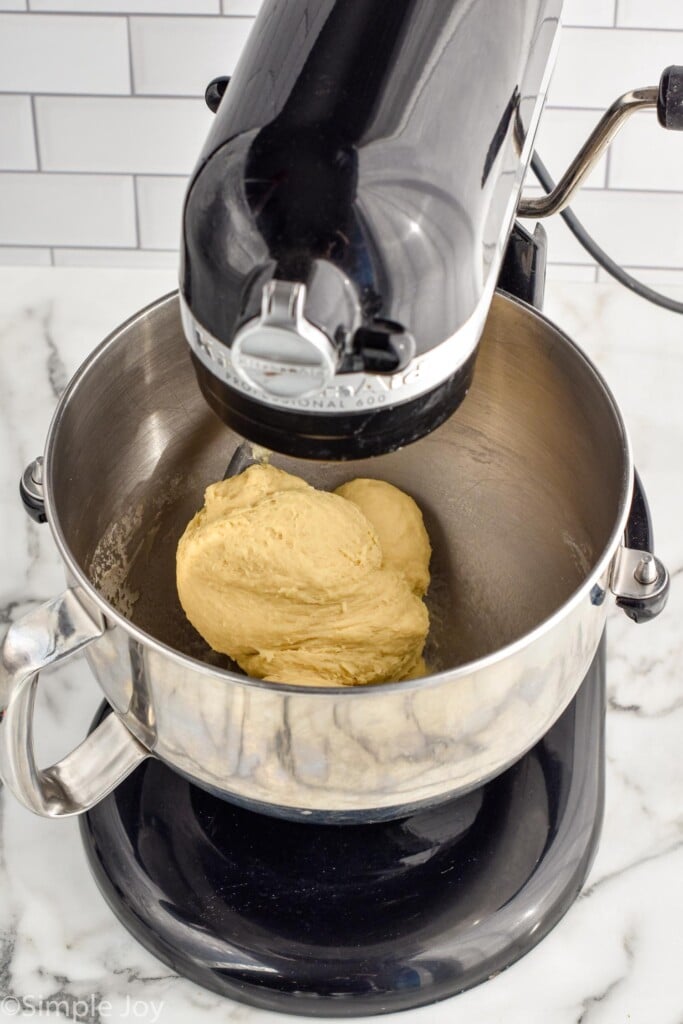 stand mixer with homemade cinnamon roll dough in bowl