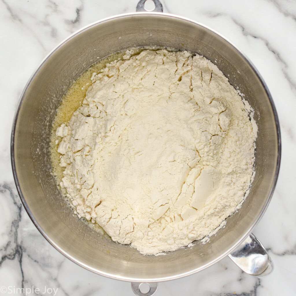 overhead of bowl of stand mixer with Homemade Cinnamon Rolls ingredients
