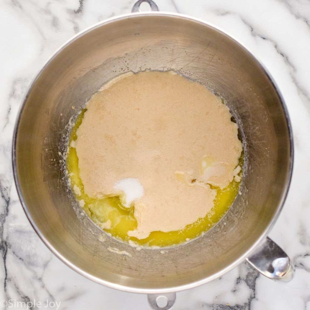 overhead of bowl of stand mixer with Homemade Cinnamon Rolls ingredients