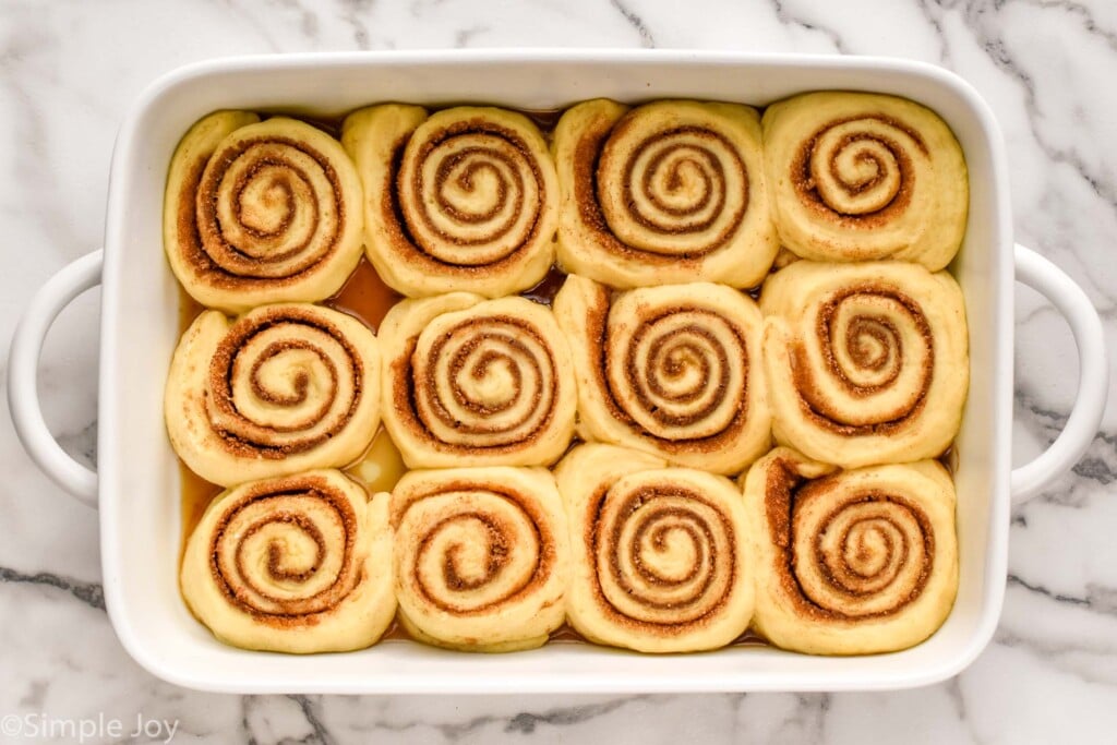 overhead of baking dish of homemade cinnamon rolls risen pre-baked