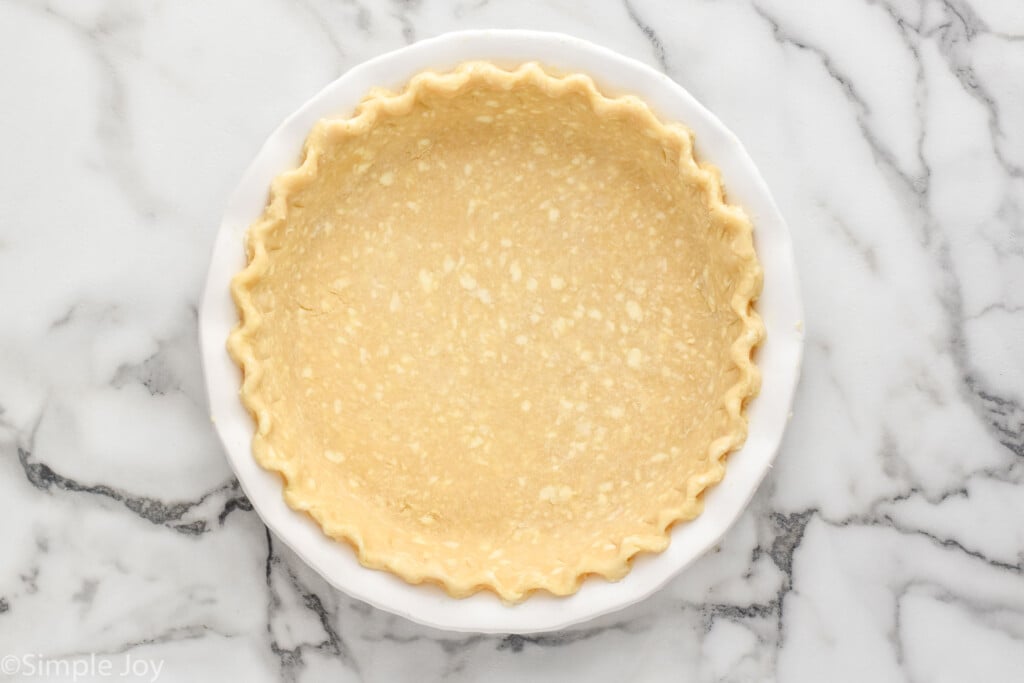 Overhead view of pie crust before baking for how to blind bake a pie crust recipe.