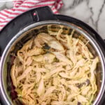 Pinterest graphic for Instant Pot Chicken recipe. Text says, "the best Instant Pot Chicken simplejoy.com." Image is overhead view of an instant pot with shredded Instant Pot Chicken recipe inside.