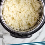 Pinterest graphic for Instant Pot Rice. Image shows overhead of instant pot with cooked rice inside. Says "Instant Pot Rice simplejoy.com"