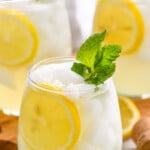 Pinterest graphic for Limoncello Spritz recipe. Text says, "the best Limoncello Spritz simplejoy.com." Image shows Limoncello Spritz garnished with lemon slice and fresh mint leaves. Lemon slices and mint leaves beside on counter.