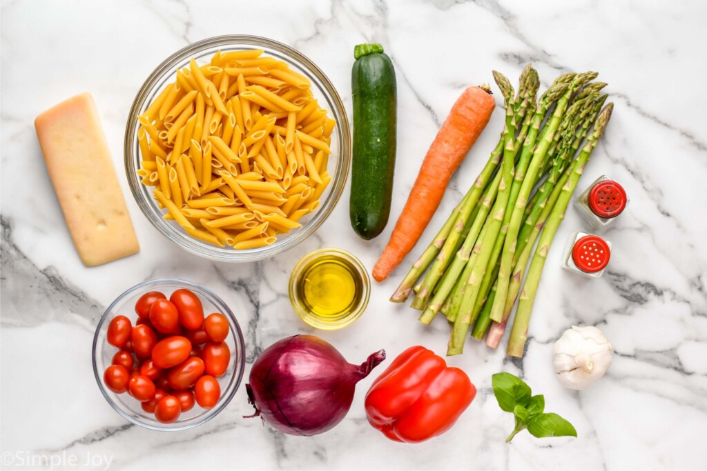 Overhead view of ingredients for Pasta Primavera recipe on countertop.