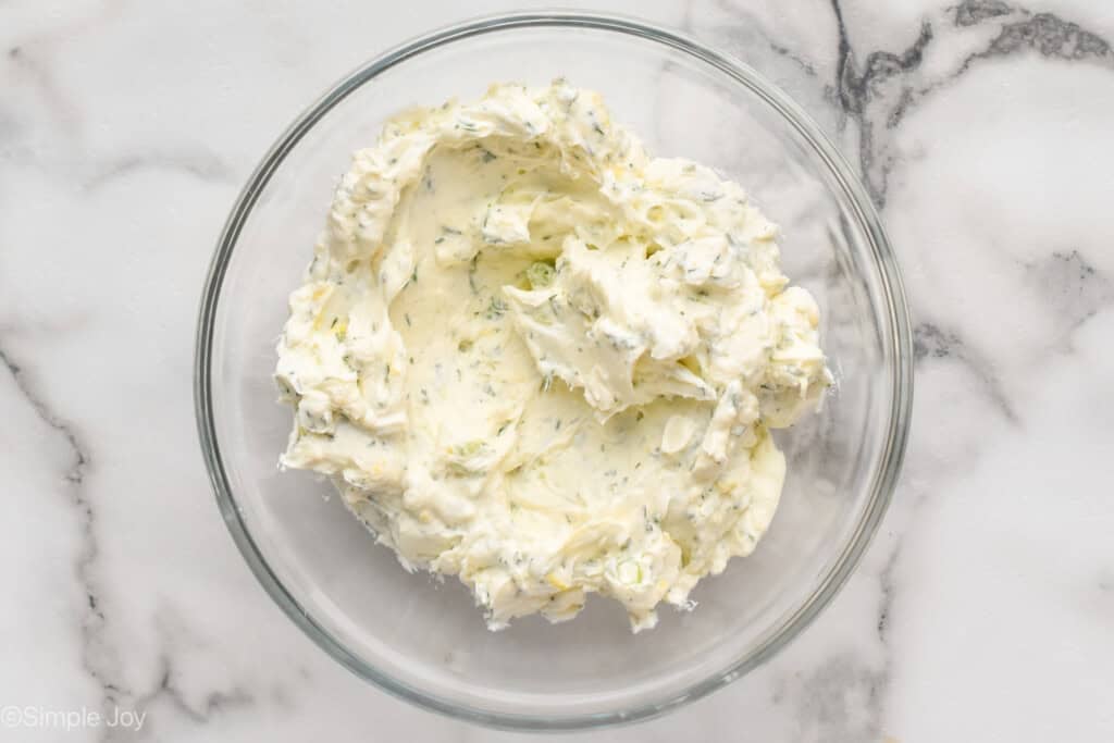 overhead of bowl of cream cheese filling mixture to make cucumber sandwich