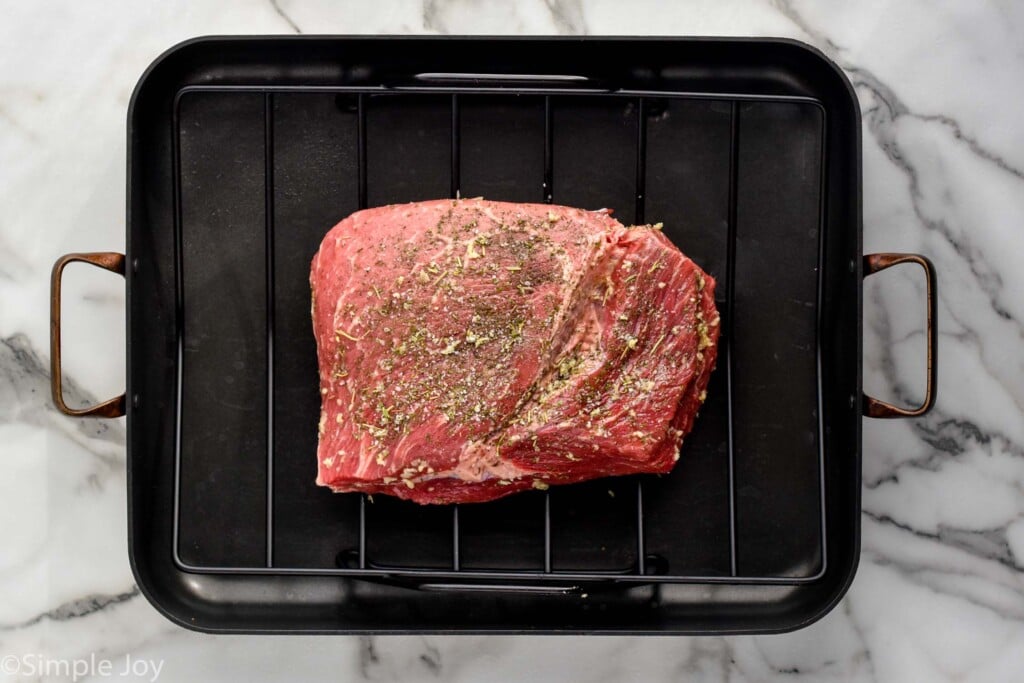 Overhead view of seasoned roast in a roaster for Sirloin Tip Roast recipe.