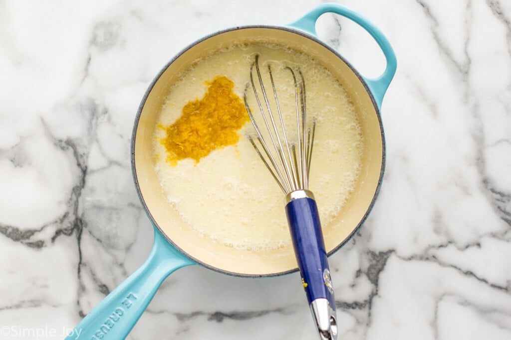 overhead of saucepan of Lemon Meringue Pie filling ingredients with a whisk