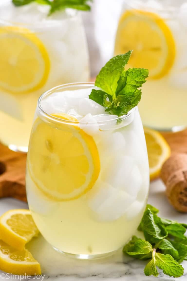 Limoncello Spritz garnished with lemon slice and mint leaves. Lemon slices and mint leaves beside.