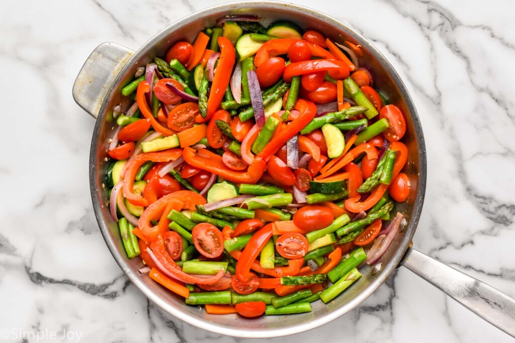 Overhead view of a pot with chopped vegetables for Pasta Primavera recipe.