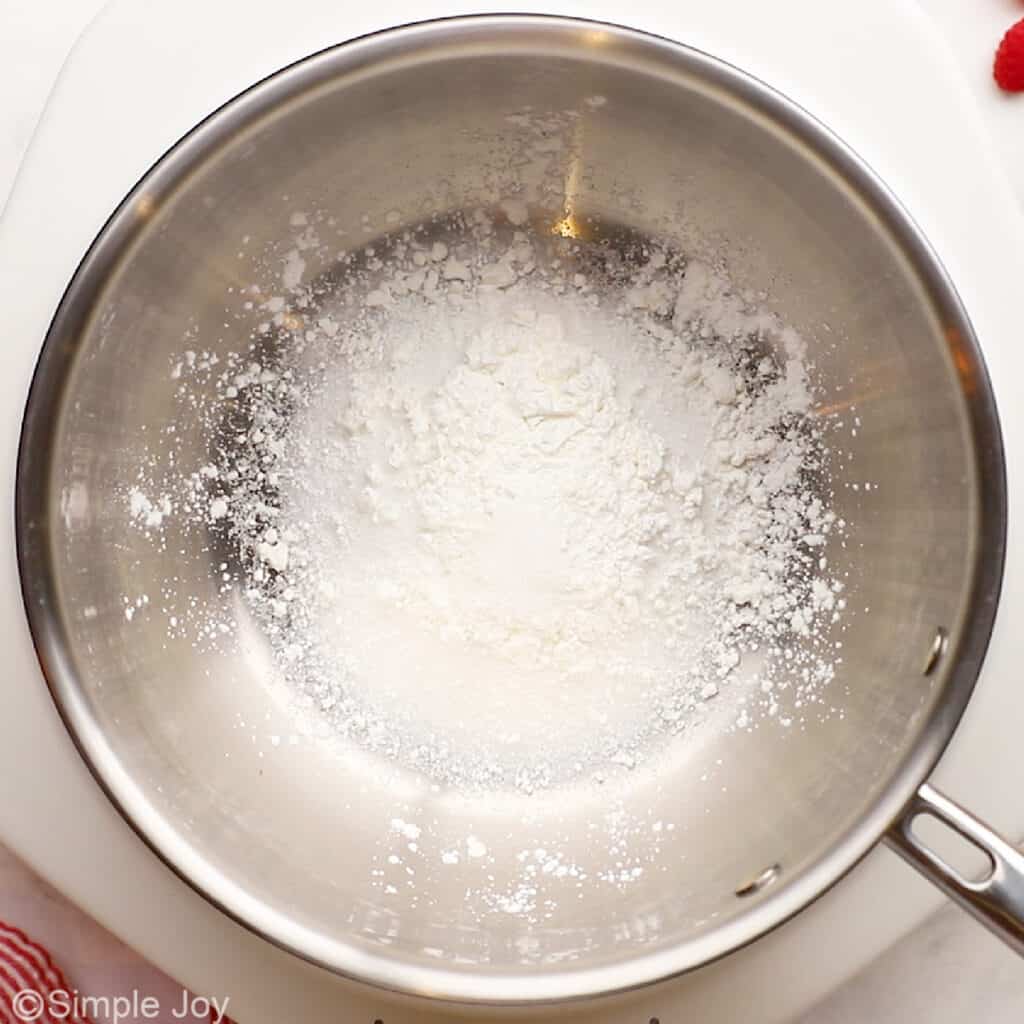 overhead of a saucepan with cornstarch, sugar, and salt in it