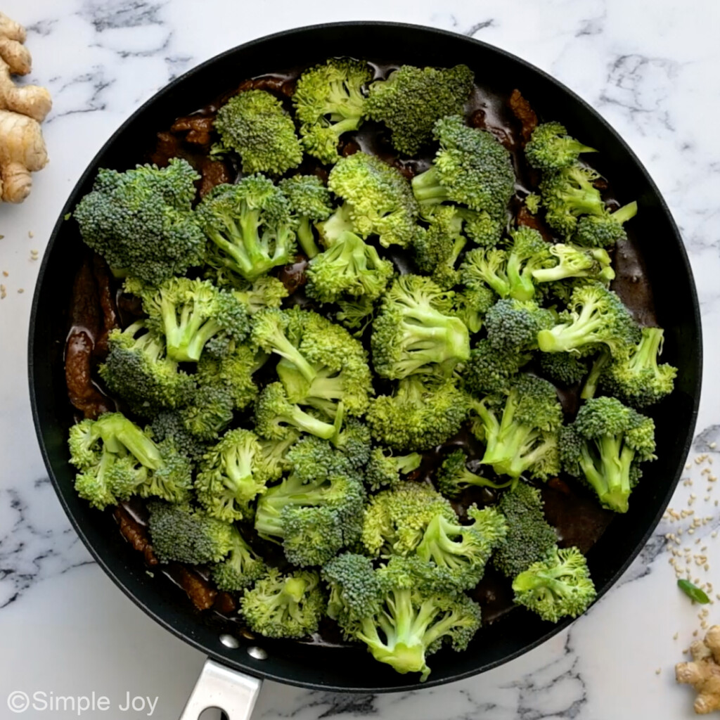 fresh broccoli added to a skillet