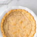 pinterest graphic of overhead of blind baked pie crust, says: "how to blind bake pie crust"