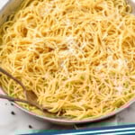 Pinterest graphic for Cacio E Pepe. Image shows a skillet of Cacio E Pepe topped with ground pepper and grated cheese. Says "Cacio E Pepe simplejoy.com"