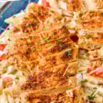 Pinterest graphic for Creamy Cajun Chicken Pasta recipe. Text says, "Creamy Cajun Chicken Pasta simplejoy.com." Image is close up view of Creamy Cajun Chicken Pasta served on a plate. garnished with parmesan cheese and parsley.