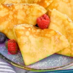 Pinterest graphic for Crepe Recipe. Image shows Crepes on a plate topped with powdered sugar and fresh berries. Says "simple and easy Crepe Recipe"