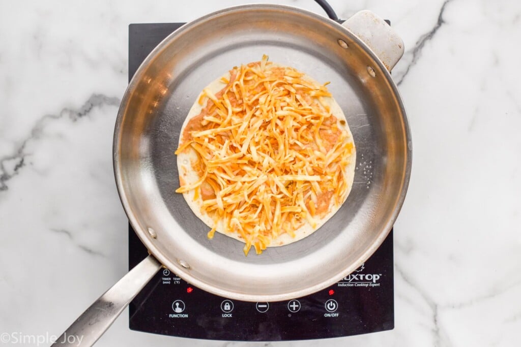 Overhead of skillet of beef quesadilla ingredients