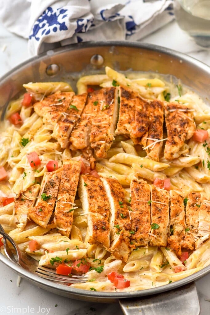 Skillet of Creamy Cajun Chicken Pasta garnished with parsley.