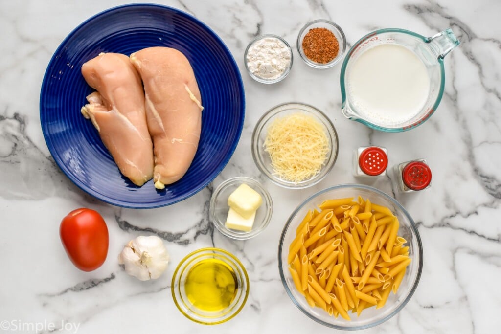 Overhead view of ingredients on countertop for Creamy Cajun Chicken Pasta recipe.