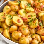 Bowl of German Potato Salad topped with fresh parsley