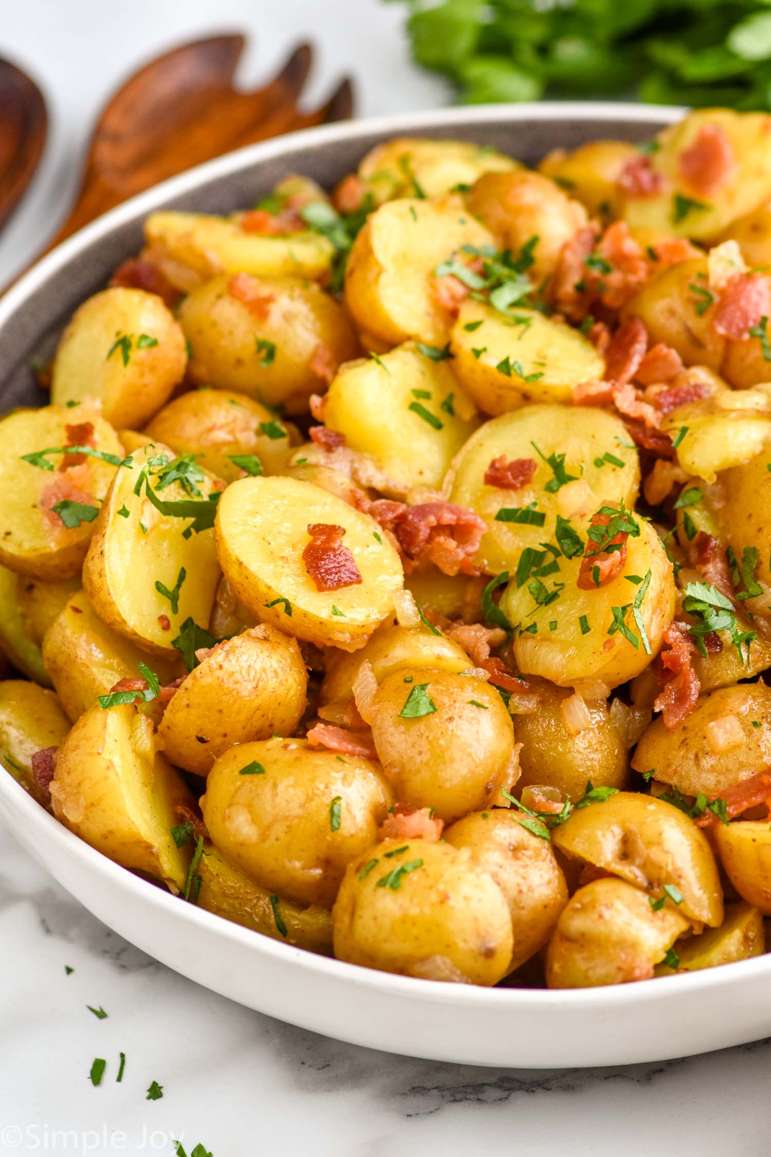 Bowl of German Potato Salad topped with fresh parsley