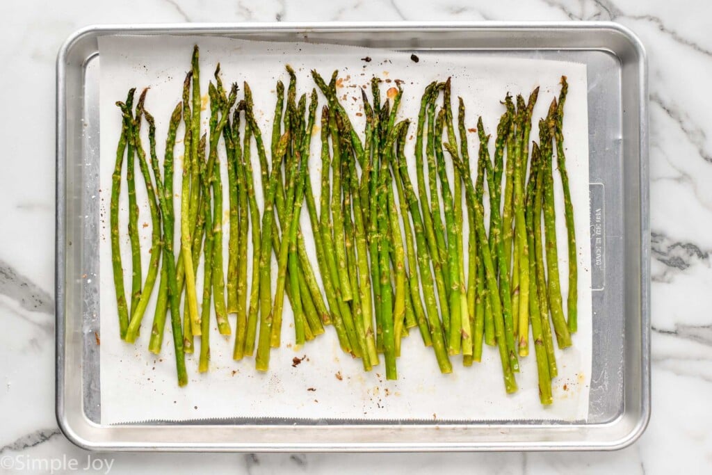overhead of rimmed baking sheet with roasted asparagus