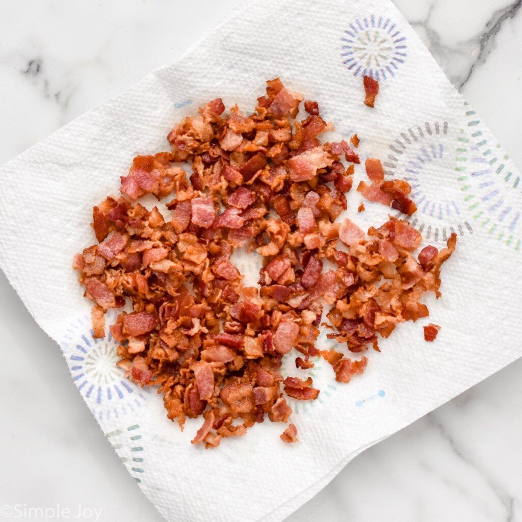 overhead of cooked diced bacon on a paper towel to make German Potato Salad