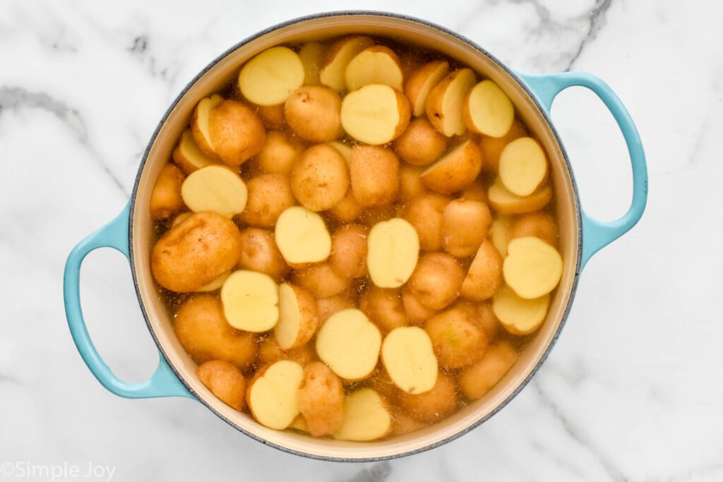 overhead of pot of water and potatoes to make German Potato Salad